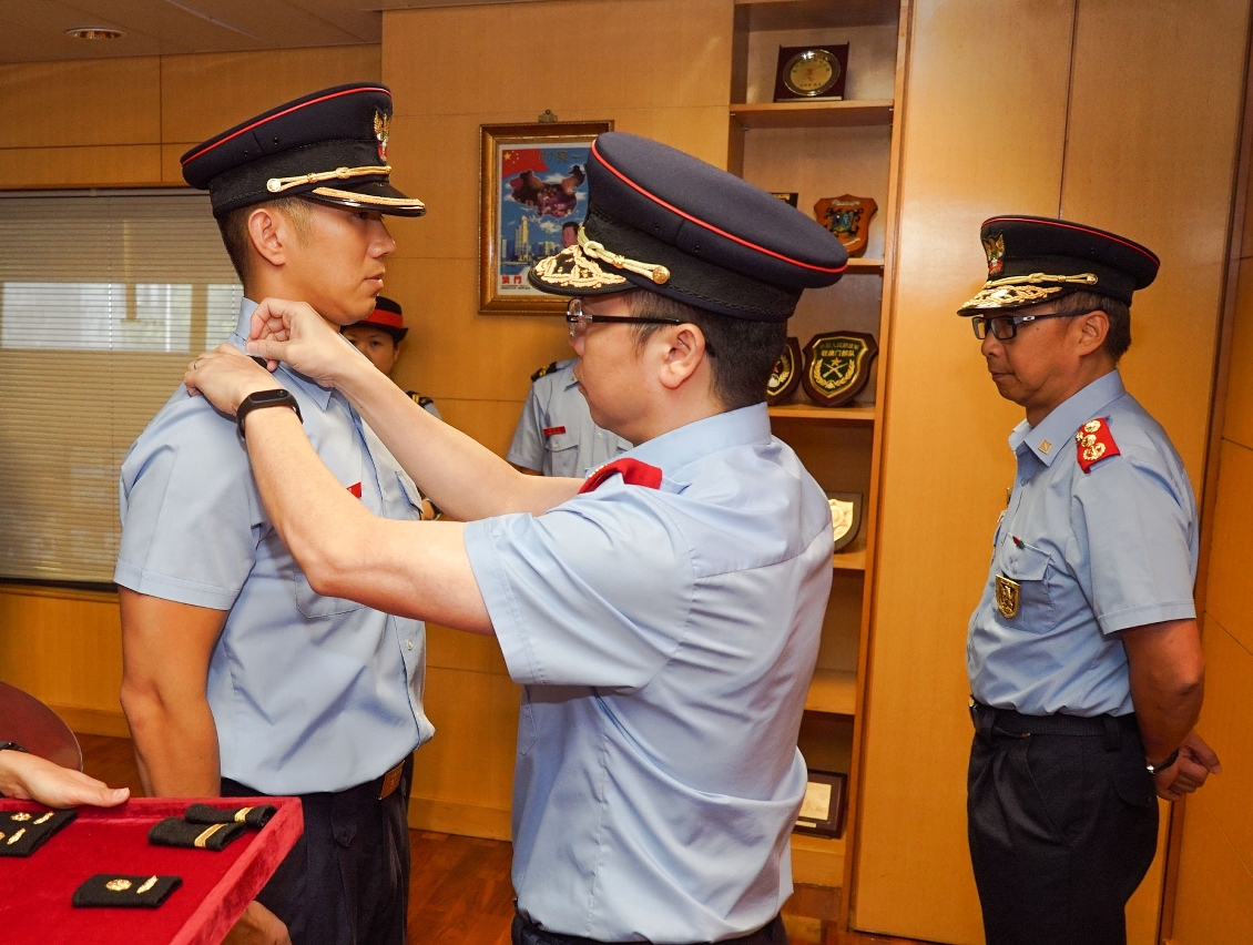 O Comandante do Corpo de Bombeiros, Leong Iok Sam, colocou o novo distintivo junto do pessoal promovido