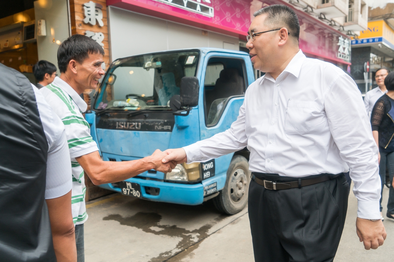The Chief Executive, Mr Chui Sai On, shakes hands with a member of the public as he tours a neighbourhood near Rua Cinco de Outubro to gain a better understanding of the post-typhoon relief effort.