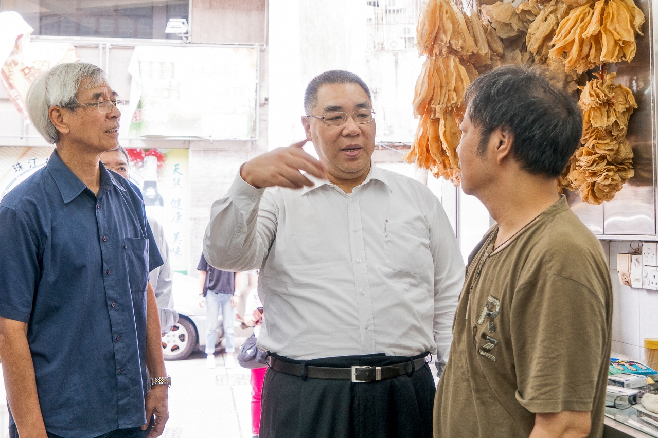 Chefe do Executivo, Chui Sai On conversa com dono de loja de mariscos secos sobre o regresso após a passagem do tufão.