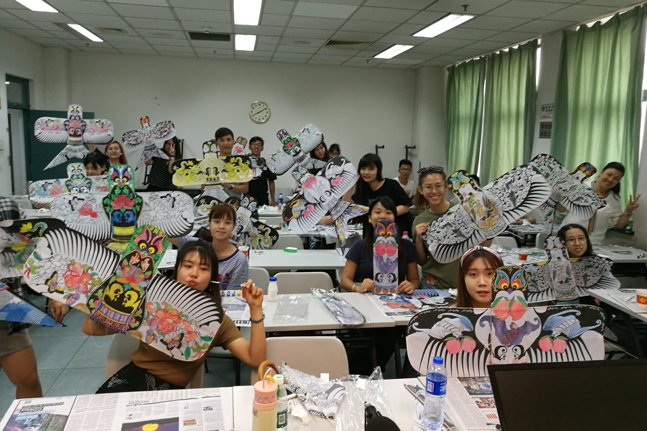 MPI students painting on traditional Chinese kites