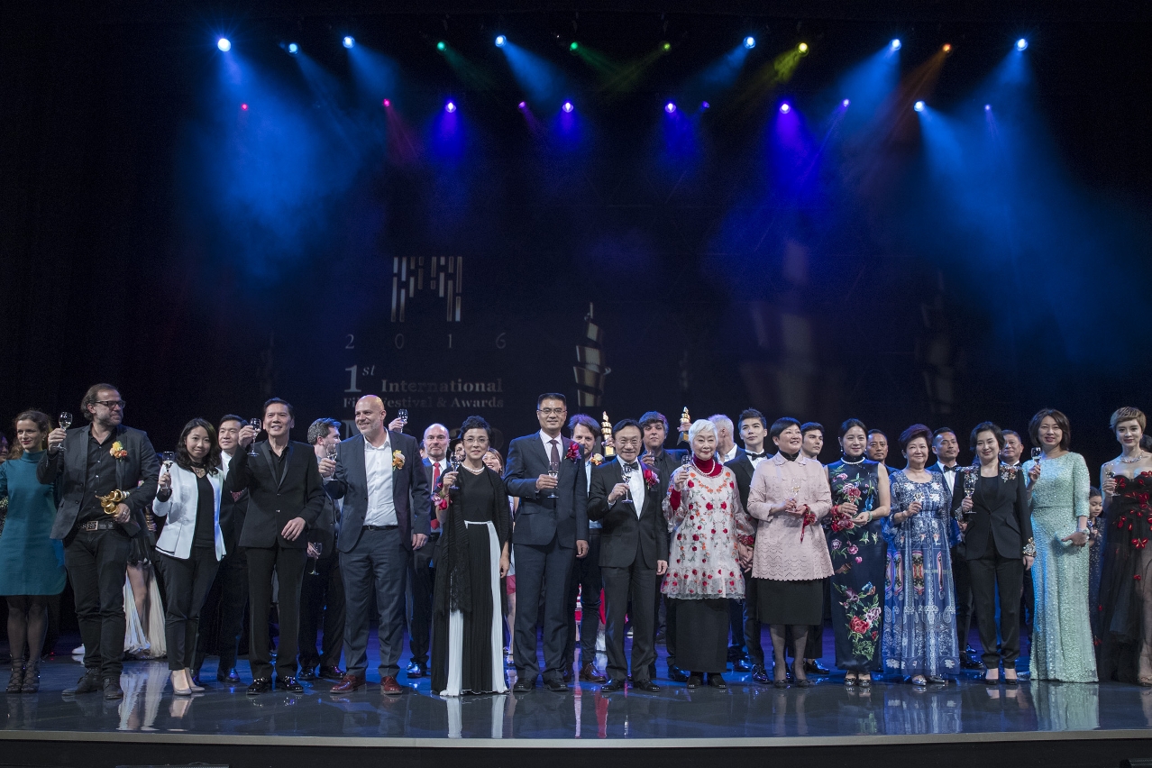 Guests and winners of the Competition Section give a toast on stage