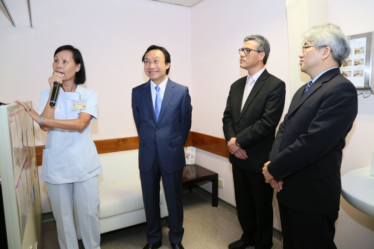 Mr Tam Chon Weng is briefed about a facility at the integrated centre for child assessment that serves mothers that breastfeed their infants