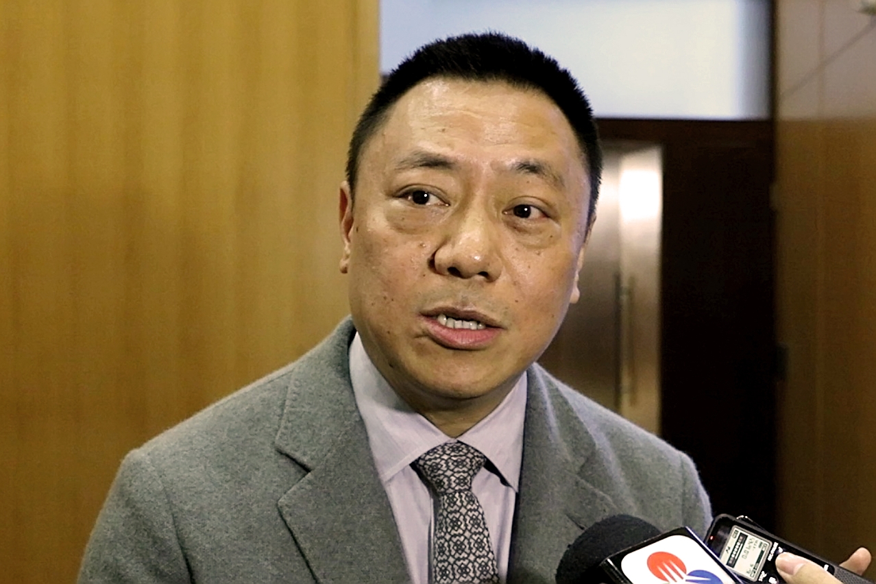 Secretary for Economy and Finance, Mr Leong Vai Tac, speaks to reporters.