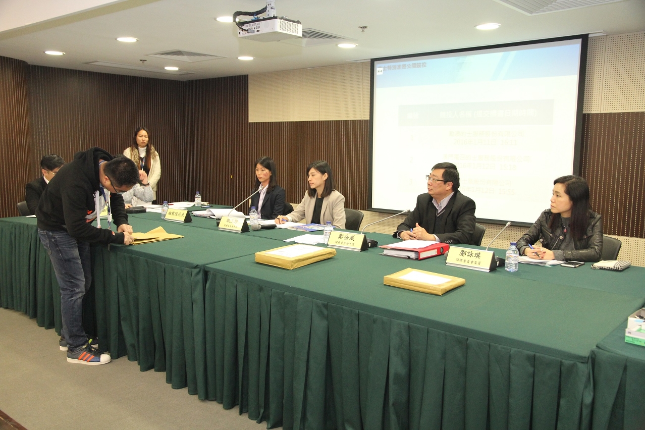 Representatives of the Transport Bureau review bids for an on-call taxi service licence.