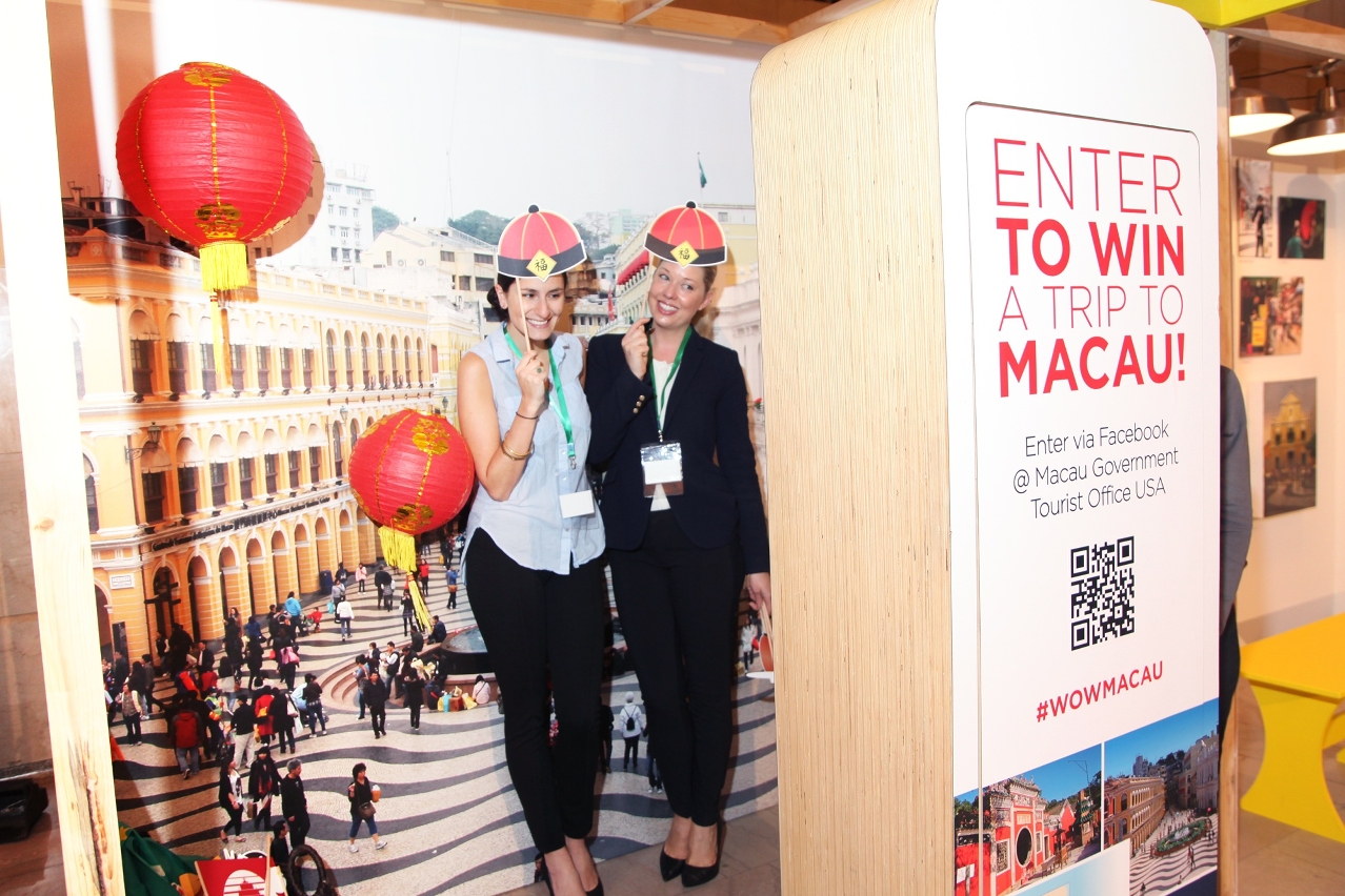 Visitors taking photo in front of Senado Square backdrop