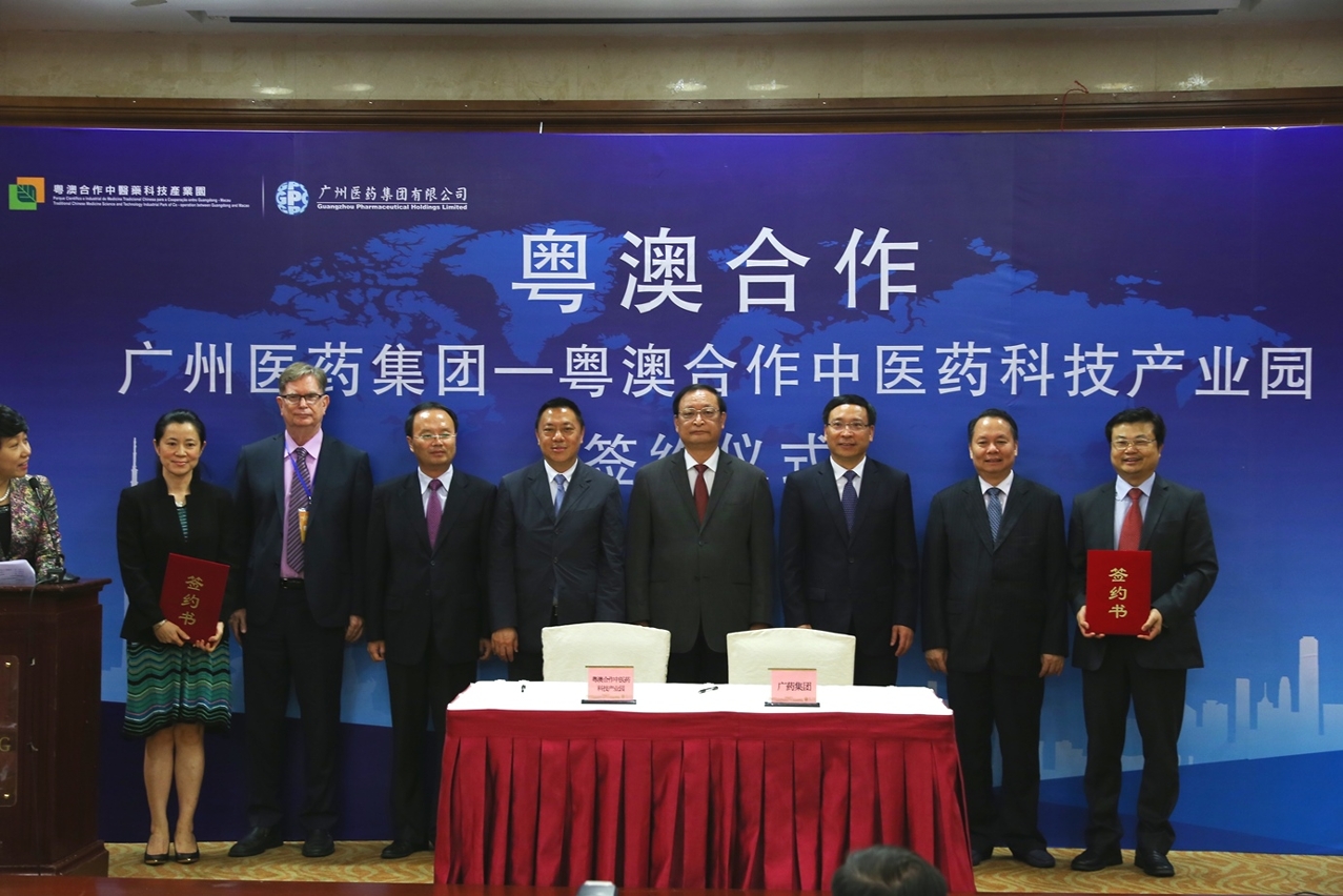 Officials pose for a group photo after the signing ceremony.
