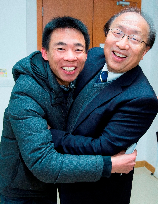 An excited student gives the rector a big hug
