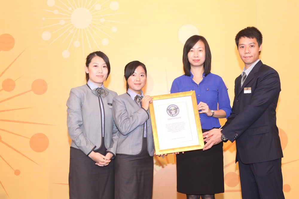 Student representative hands over the Guinness World Record Certificate to IFT and the certificate is received by President of IFT, Dr. Fanny Vong.