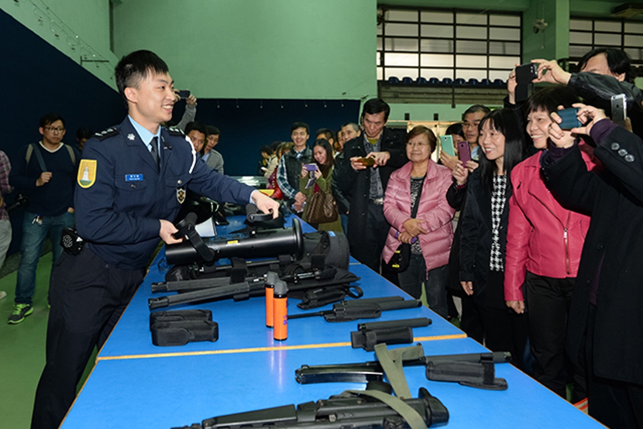 Police officer shows equipment of the Police Tactical Intervention Unit to visitors.