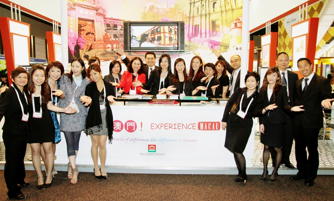 Group photo of local trades in front of MGTO's promotional booth