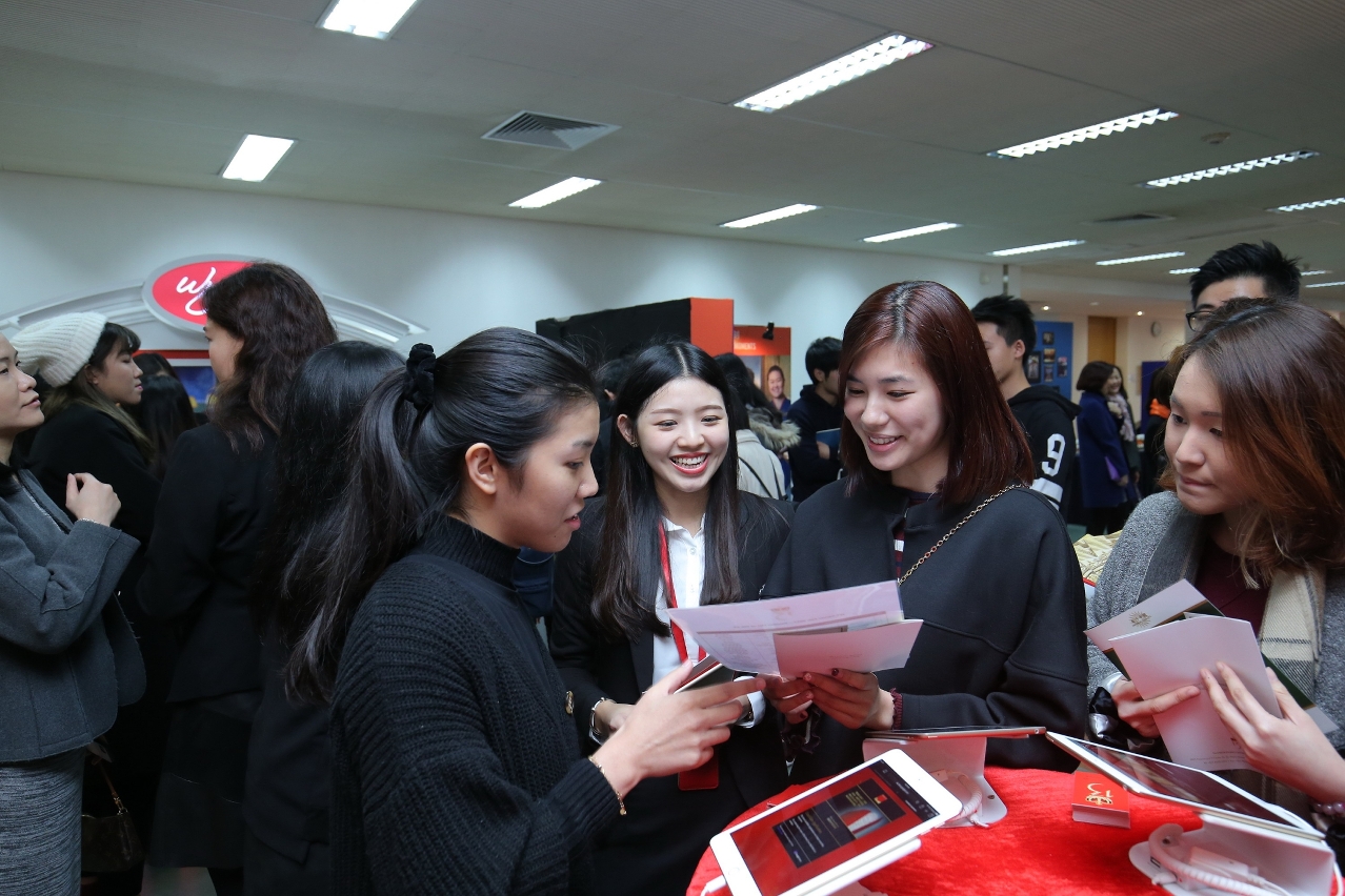 Students enthusiastically enquiring about job opportunities.