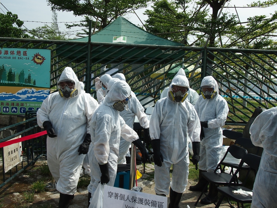民政總署和衛生局滅蟲鼠人員穿著防護裝置進入封鎖現場進行滅蟲鼠工作