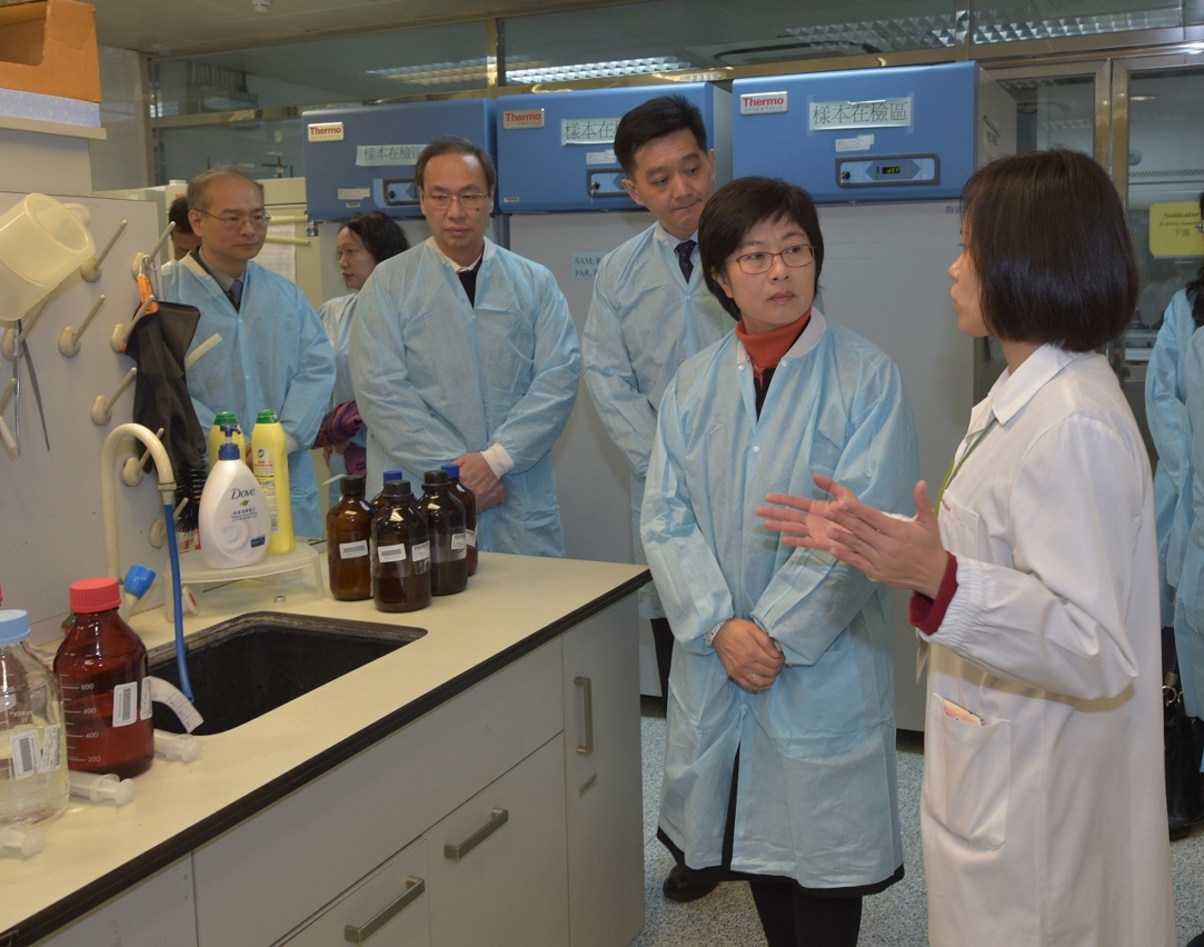 Secretary for Administration and Justice, Ms Chan Hoi Fan, listens to a briefing on water testing procedures.