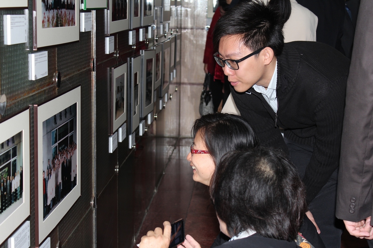 Visitors showing interest in the photographs on display